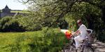 Cycling by the church Flying Boat Cottages, United Kingdom, Cycling by the church